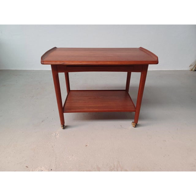 Fully restored Danish teak bar cart with integrated tray, 1960s. The well designed table with an integrated teak tray is...