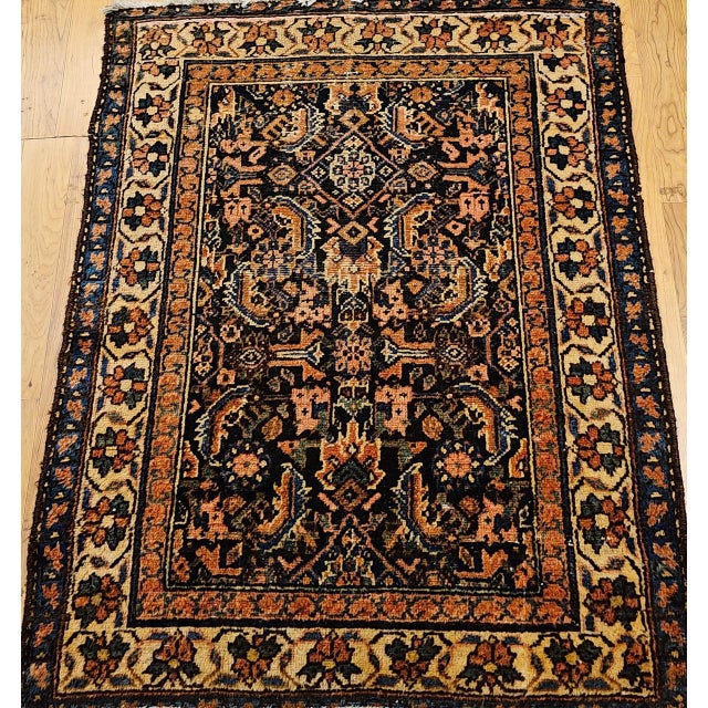 "This antique Persian Malayer rug from the early 1900s presents the classic Herati allover design in a deep navy-blue...