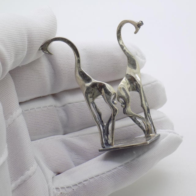 A sleek and stylized vintage piece, this Italian miniature features a pair of modernist giraffes rendered in solid silver...