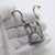 A sleek and stylized vintage piece, this Italian miniature features a pair of modernist giraffes rendered in solid silver...