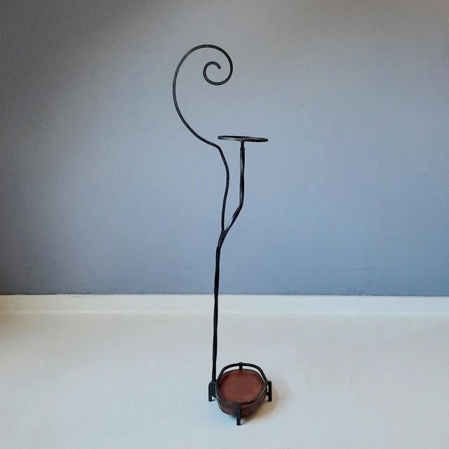 This French walking stick stand from the 20s/30s features a wrought iron frame and a plywood bottom.