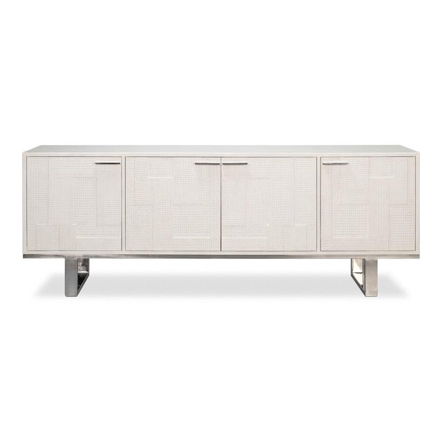 A long, low white-leather case rests above an iron base, giving the broad form an airy, architectural presence. Four flush...