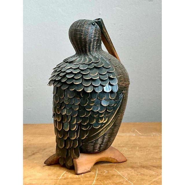 Crafted from warm-hued rattan, this captivating vintage pelican basket showcases an exceptional mastery of the traditional...