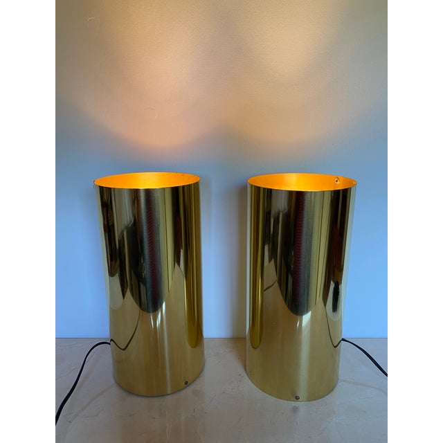 A striking pair of vintage brass cylinder table lamps designed in the style of Robert Sonneman, embodying the clean...