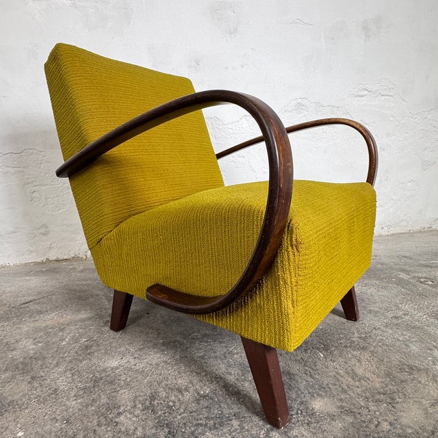 Original halabala type c armchair with a stable structure and strong, well-preserved wooden armrests. The iconic bentwood...