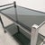 Vintage trolley, circa 1970, with a robust geometric frame in high-quality chrome metal. it features two smoked glass...