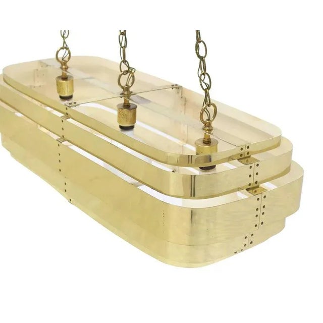 Mid-Century Modern brass light fixture pendant suspended on long chains. May be used as a pool table fixture.