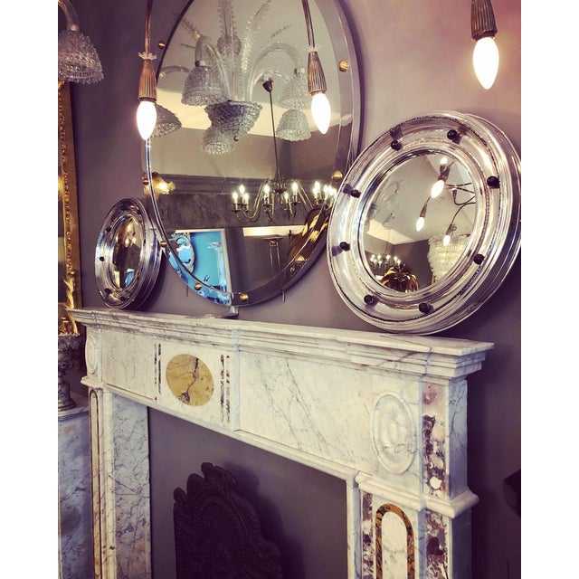 A George III Irish, fireplace surround, in old English marble with a wide breakfront shelf, inlays of convent sienna and...