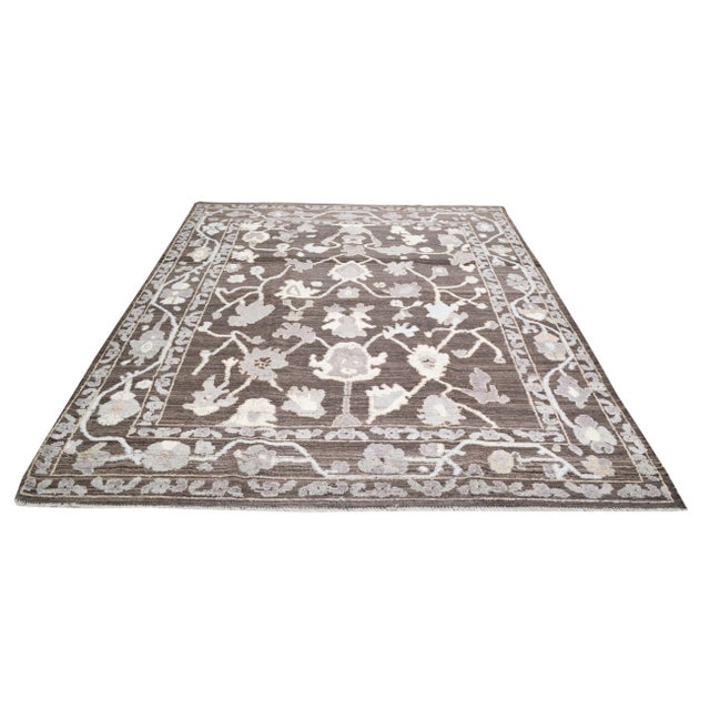 Oushak Hand-knotted with care using traditional rug-making techniques, this wool rug blends timeless craftsmanship with a...