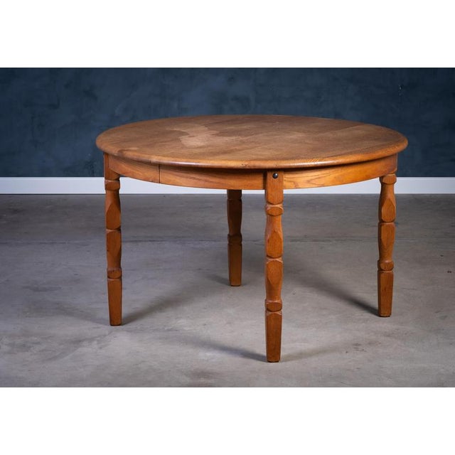 Dining table in solid oak, designed by Henning Kjærnulf in the 1970s. The table features a strong Brutalist aesthetic and...