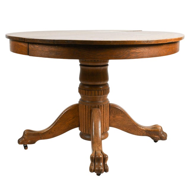 This Antique Oak Pedestal Dining Table is a handsome example of traditional American craftsmanship, combining sturdy...