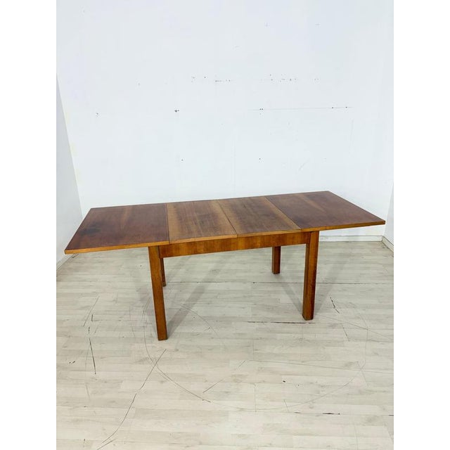 Charming, extendable dining table in a timeless Art Deco design, perfectly combining functionality and Scandinavian...