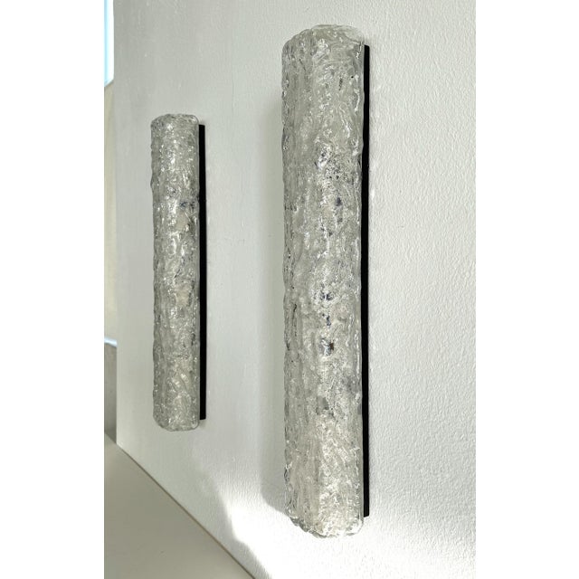 Exceptional pair of long tube hand-crafted Murano textured ice glass wall lights on a metal base manufactured by Glashütte...