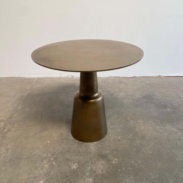 Aged Patina brass finish, this table works well as a bistro table, or use as an entry center table. The top has a...
