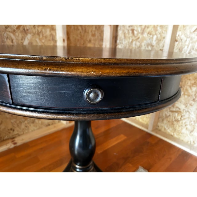 This beautifully crafted, solid wood foyer table, manufactured by Hooker Furniture Company, has a two toned color...