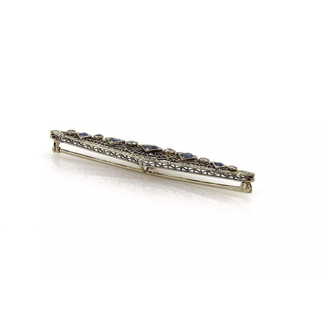 This is a lovely Are Deco brooch, it is crafted from solid 14k white gold, it has a long fancy open filigree design and is...