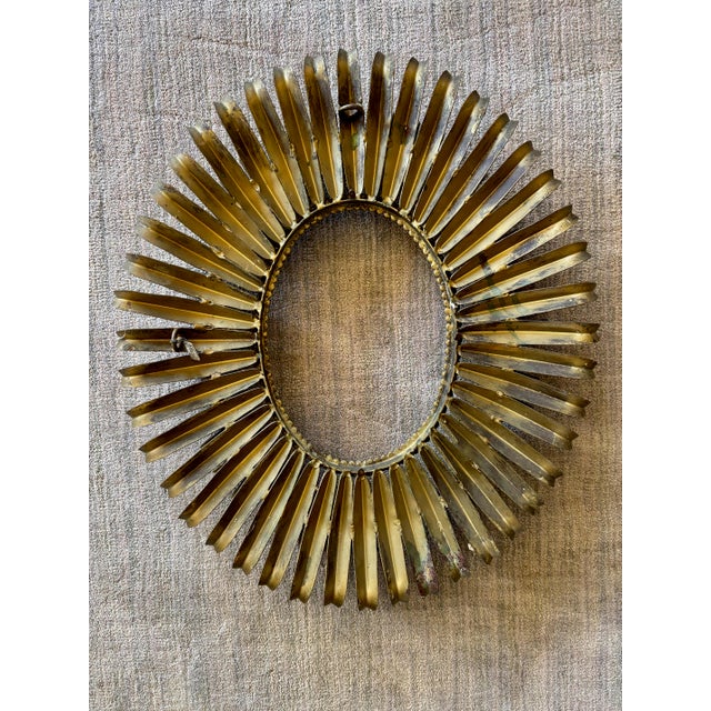 Nice vintage Spanish made gilt gold tole metal Hollywood Regency antique oval sunburst style wall accent mirror in the...