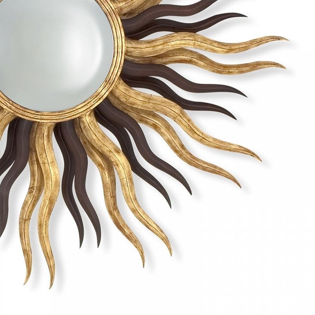 An exceptional and authentic vintage "Sunset" elliptical sunburst wall mirror, hand-carved in solid mahogany by the...