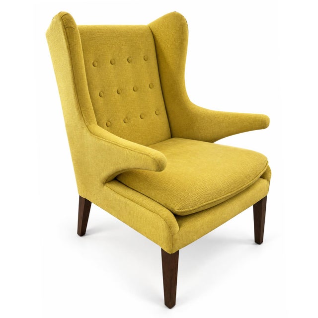 Make a bold statement with this striking chair featuring vibrant lemon-yellow upholstery and a classic wingback...