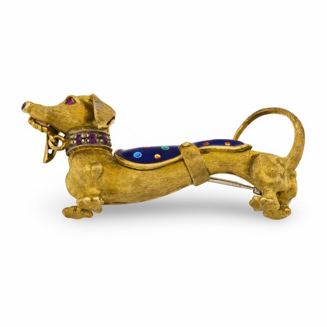 This vintage brooch from the 1970’s is crafted in 18k yellow gold with intricate enamel detailing, set with six round cut...