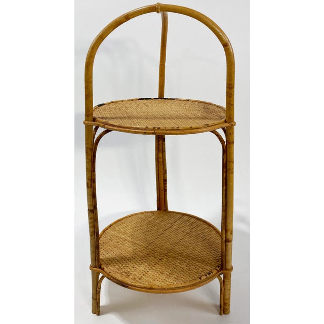 Wonderful vintage scorched bamboo two tier serving stand. Features sturdy bamboo frame with two round caned surfaces for...