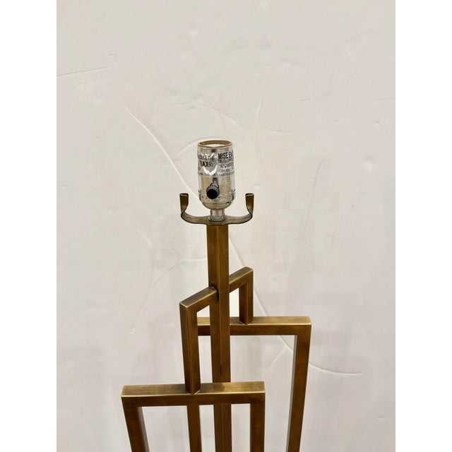 Modern Sculptural body Antique Brass Lamp on rectangular acrylic base. Showroom floor sample.