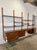 This four-bay modular wall unit offers versatile adjustable open shelving and lower storage compartments. The floating...