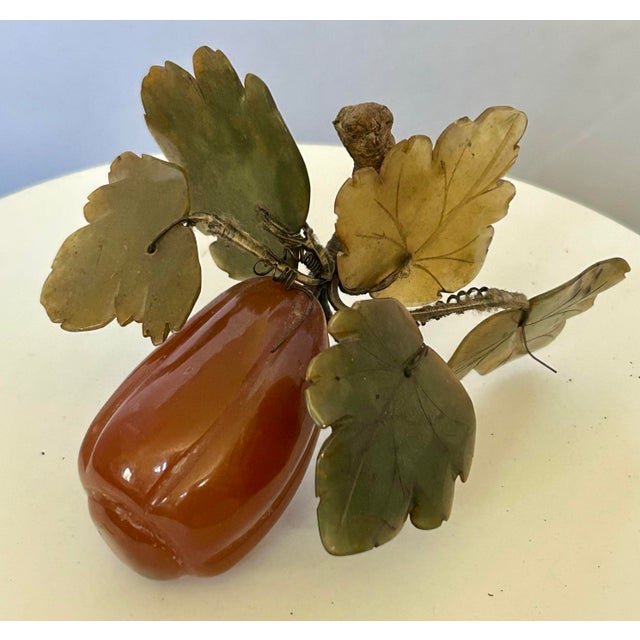 Vintage pair of Chinese carved stone fruit, featuring an orange carnelian and agate grapes with carved jade leaves and...