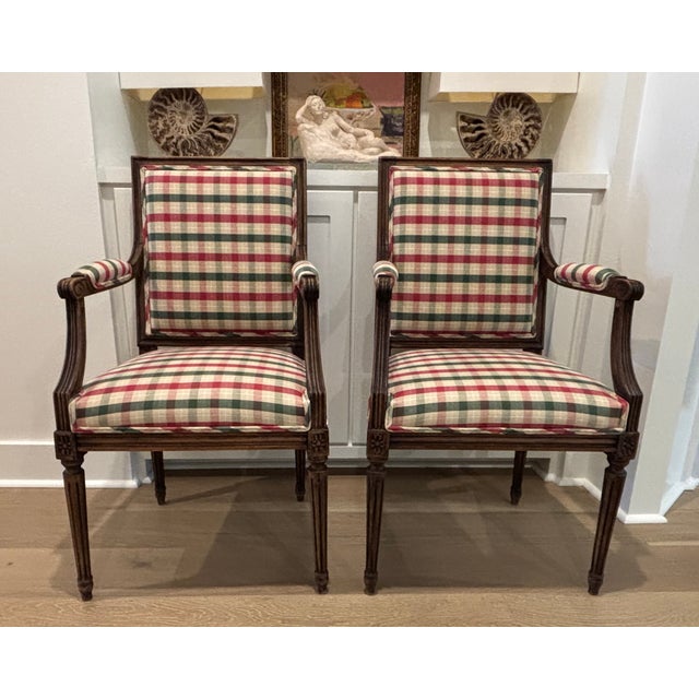 Pair of vintage Louis XVI style open armchairs with carved wood frames ORIGIN: France CIRCA: Early 20th Century (exact age...
