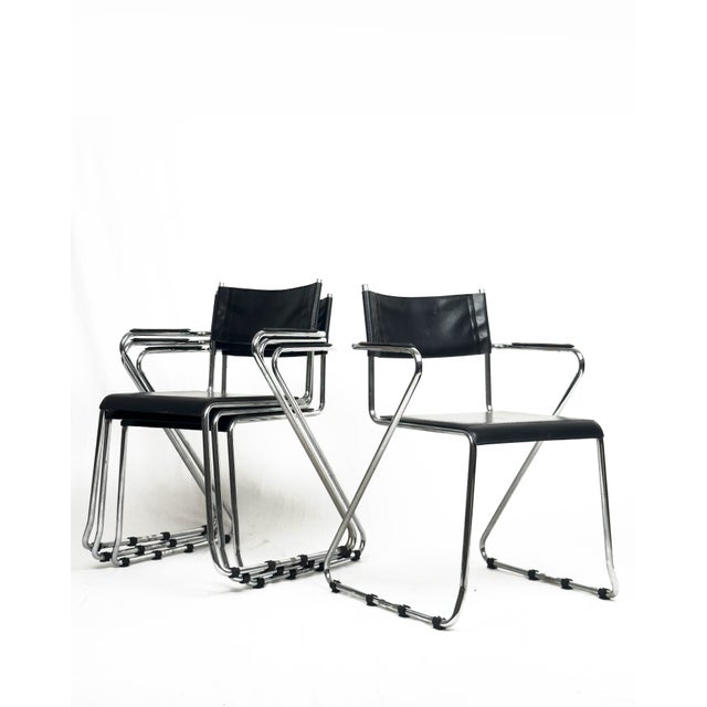 A set of 4 vintage cantilever chairs with a clean architectural silhouette, combining a polished chrome tubular frame with...