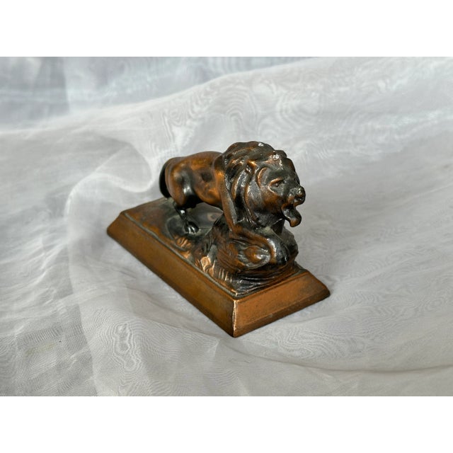This antique metal lion figurine is an interesting early 20th-century artifact. The vintage bronze lion appears to be a...