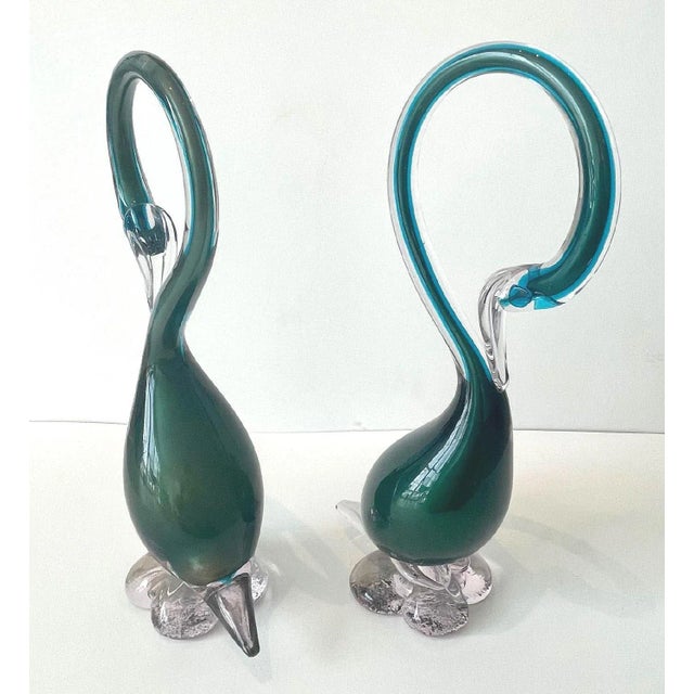 These hand blown Murano glass swans are clear with teal blue & green. The colors are beautiful in person. They measure 12...