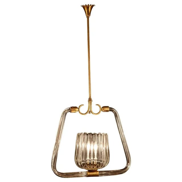 Chandelier with essential design and great elegance attributed to Gio Ponti. Centered by an amazing hand blown cup with...