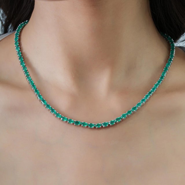 The Regal Green Onyx Necklace and Ruby Stud Earrings Jewelry Suite brings together rich green hues and vibrant ruby-red...