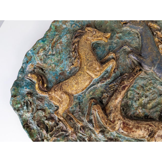 A large and important hand-decorated terracotta wall plaque/sculpture by the Faenza master Angelo Ungania, likely created...