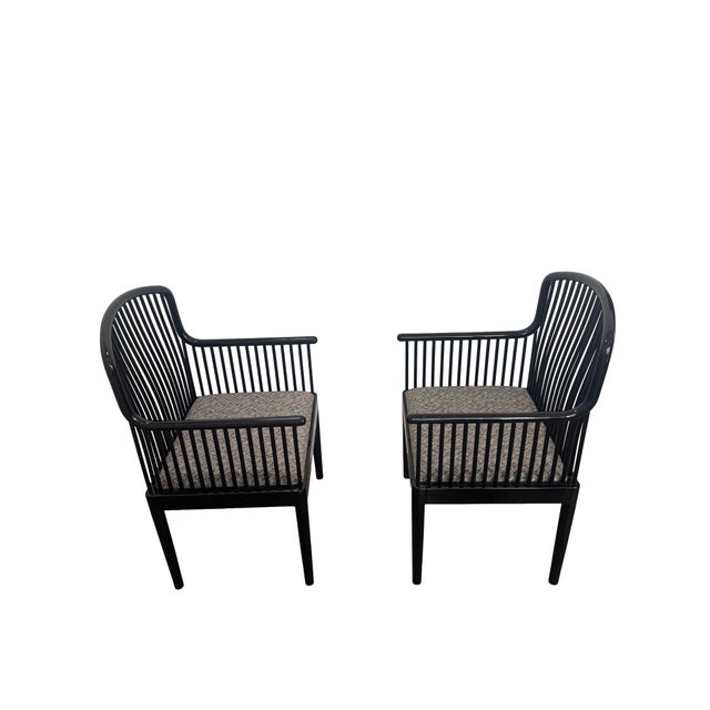 Offering an exceptional pair of Andover black lacquered spindle armchairs. The chairs were designed by Davis Allen and...