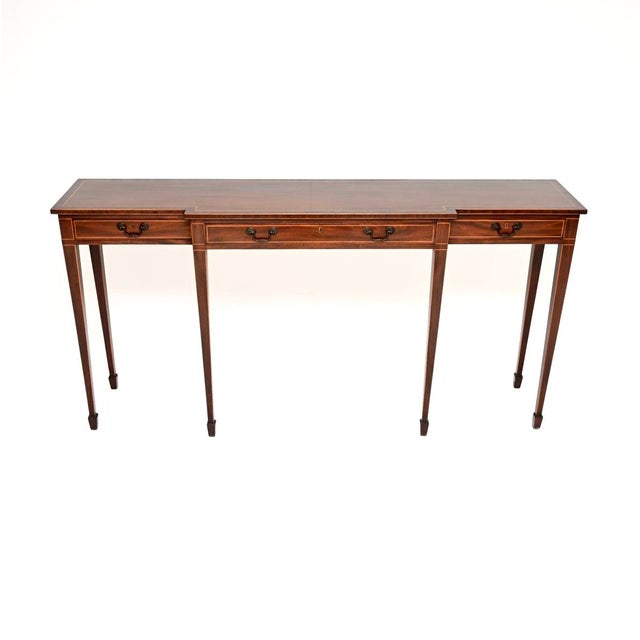 An impressive and incredibly well made large antique inlaid console table. It is in the Georgian style, it was made in...