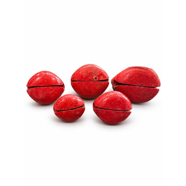 A graduated set of five vintage carved wooden fish temple blocks in a beautiful watermelon-red finish with gold-tone and...