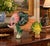 A vintage Italian hand-painted majolica elephant sculpture featuring an imaginative trompe l'oeil composition of fruits,...