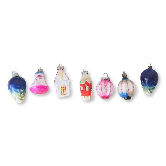 Set of seven milk glass ornaments, ingeniously repurposed from early 20th-century holiday lights. Their creamy, opalescent...