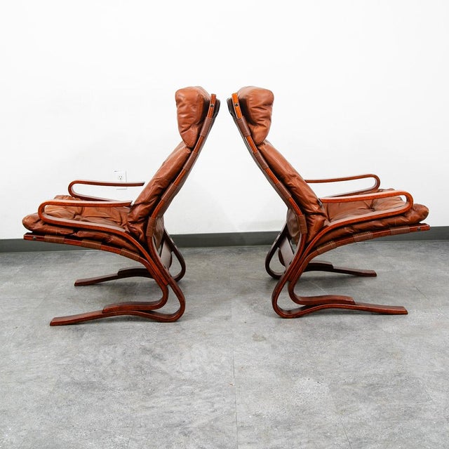 Matching bentwood and brown / cognac leather lounge chair set. Uniquely designed with a sling style seat and plush leather...
