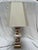 A single vintage baluster form porcelain lamp with traditional Imari style gilt decoration. Includes hard back lamp shade....
