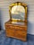 Vintage Art Deco waterfall dresser with an attached arched mirror featuring amber-tinted glass panels and geometric wood...