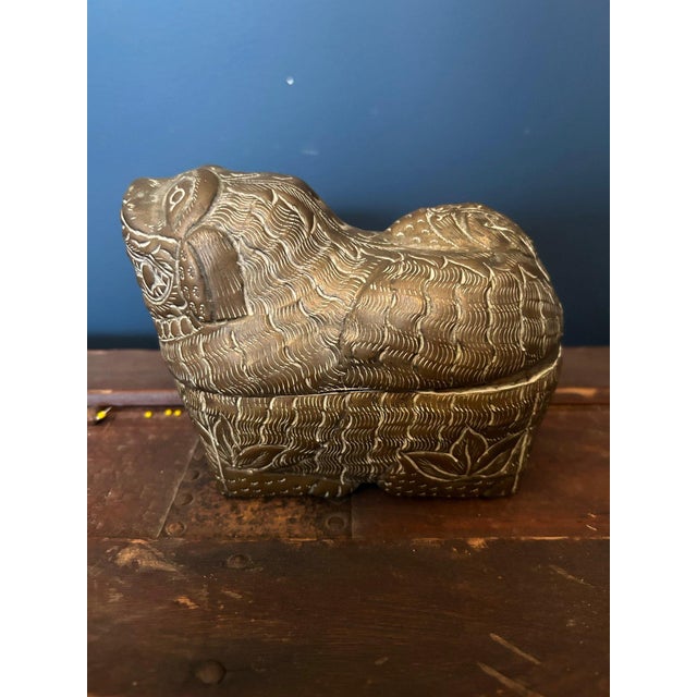 A beautifully detailed antique Chinese brass Foo Dog trinket box featuring a sculptural guardian lion form with rich...