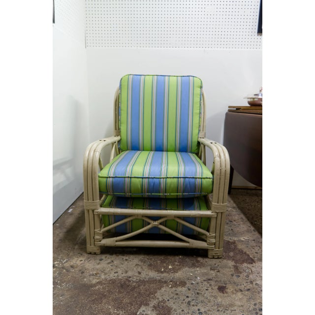 A stylish vintage bamboo and wicker armchair with a sculptural, airy frame that adds warmth and texture to any space....