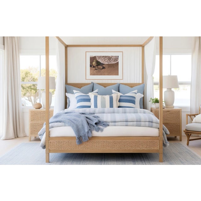 This fine art photograph features footsteps on the beach as the tide comes in. Photograph by Paula McIntosh, taken in...