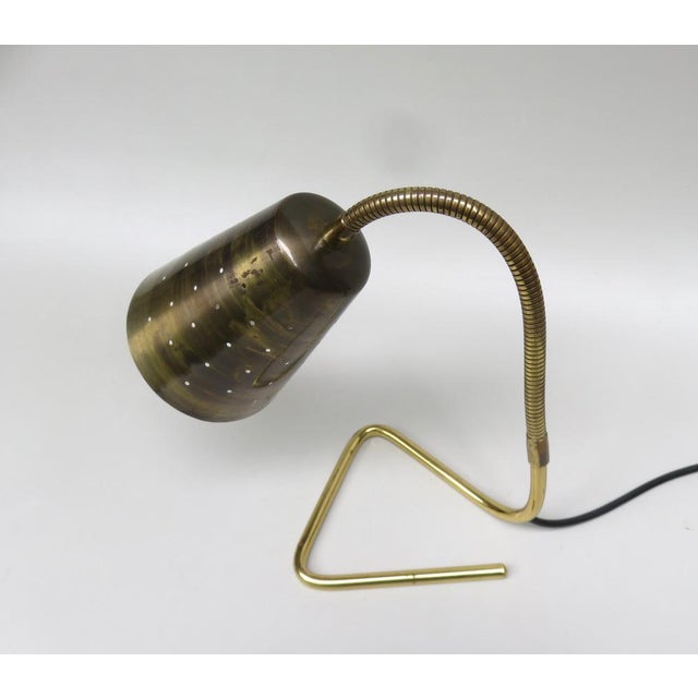 An elegant, petite table lights from the 1950s in a Scandinavian design made of brass polished in combination with brass....