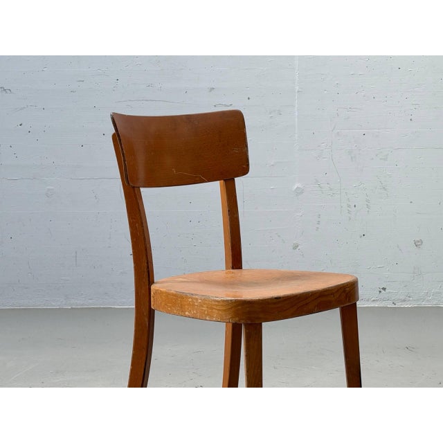 A simple yet distinctive vintage wooden chair from switzerland, with the original workshop label from the a. Brandenberg...