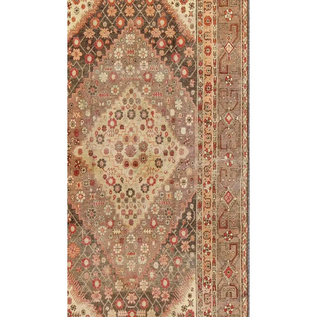 Measures: 6'4 x 11'6 This beautiful Khotan rug, from early 20th century Turkestan features layered medallions in geometric...