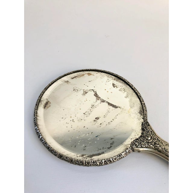 Beautifully designed heavy vintage hand mirror with hand-decorated putti motif on porcelain, handle and rim decorated in...